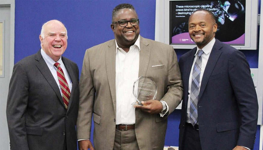 James W. Hunt Jr. (left), Stan McLaren (center), and Michael Curry (right) with award